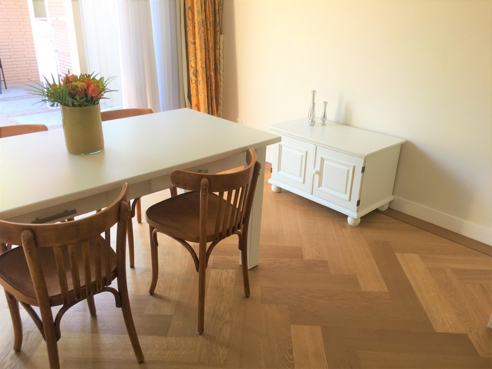 Great looking '60 chairs go well with the modern off-white table and cabinet